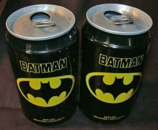 two batman canisters are sitting next to each other