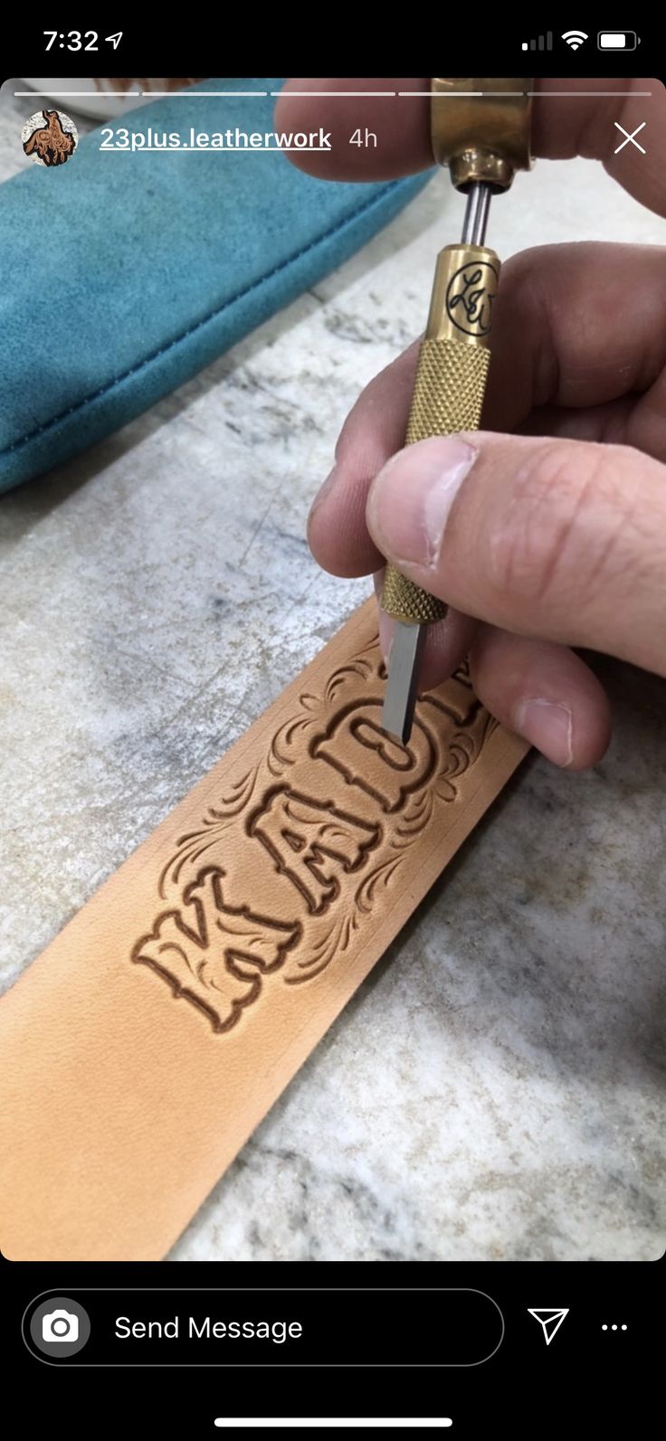 a person is using a small tool to cut out the word on a piece of leather