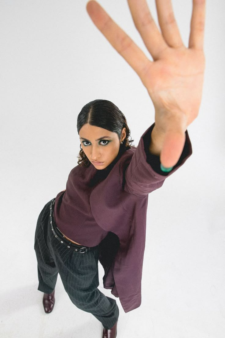 a woman is holding her hand up in the air