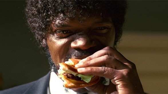 a man in a suit eating a sandwich