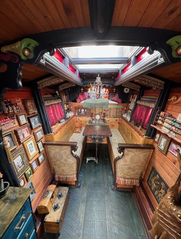 the inside of an old train car with pictures on the walls