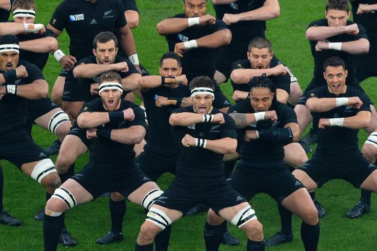 a group of rugby players in black uniforms