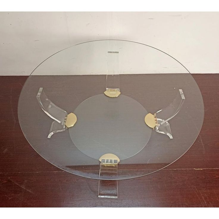 a glass plate with two metal handles on a wooden table