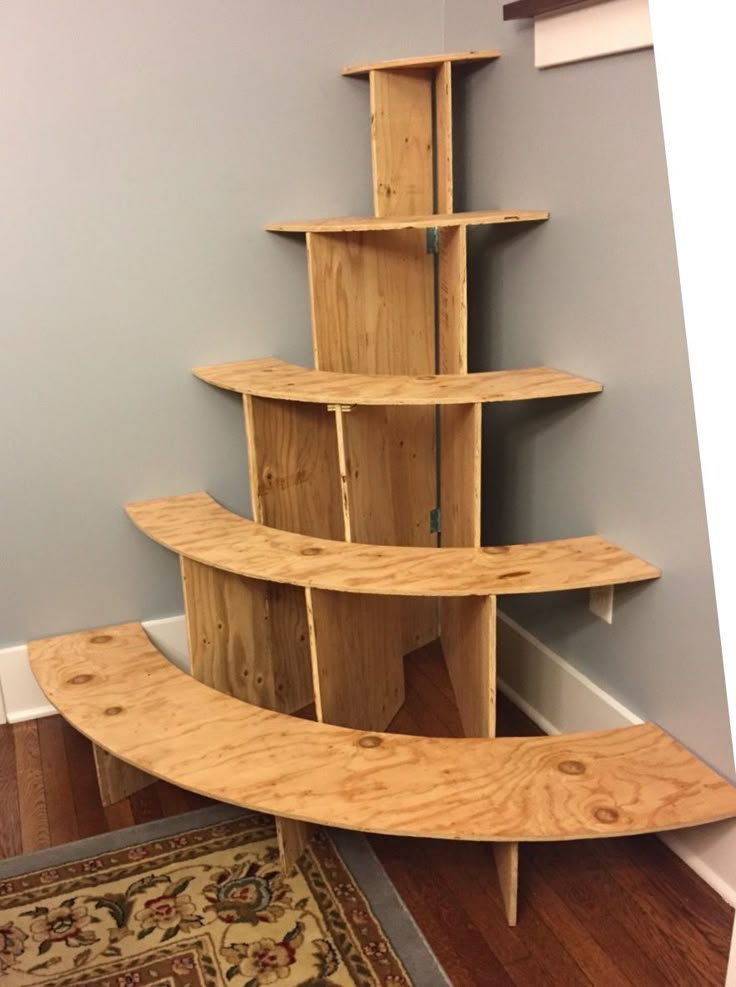 a wooden shelf sitting on top of a hard wood floor next to a rug and door