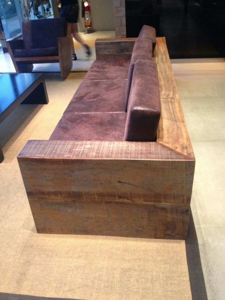 a wooden bench sitting on top of a carpeted floor