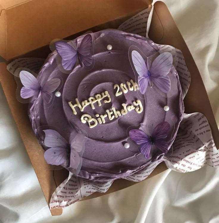 a purple birthday cake in a box with butterflies on it and the words happy 25th