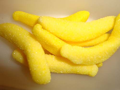 several pieces of yellow food sitting on top of a white bowl