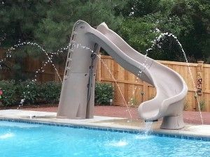 a water slide next to a swimming pool