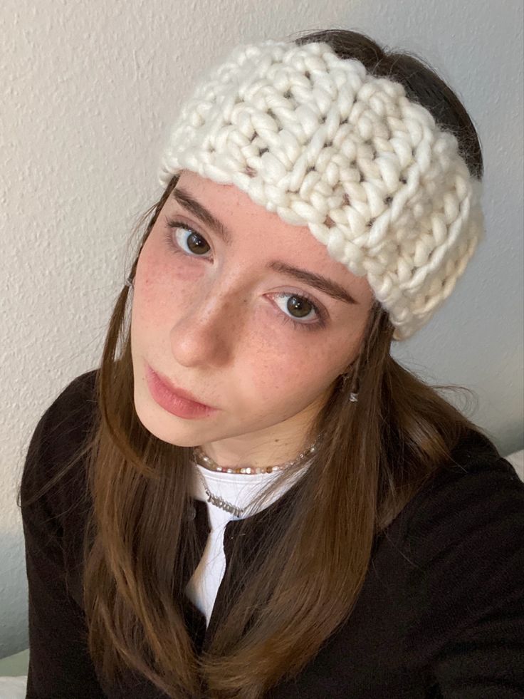 a woman wearing a white knitted headband