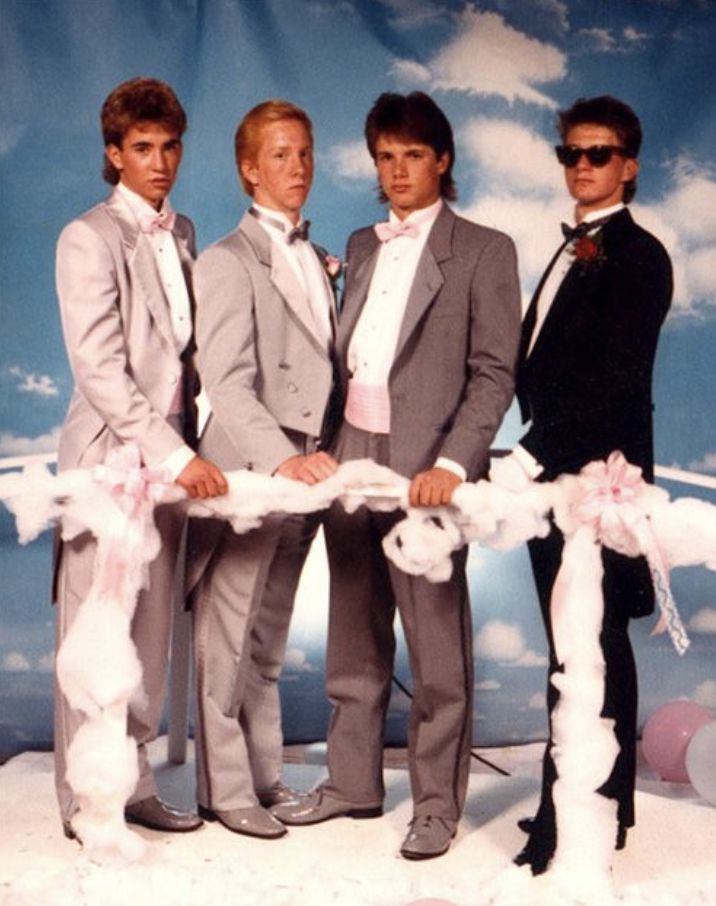 three men in suits and ties are standing next to each other