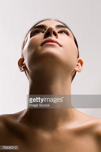 a woman with her eyes closed looking up