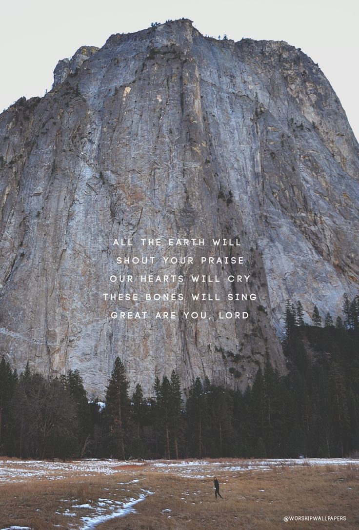 a person standing in front of a large mountain with a quote written on the side