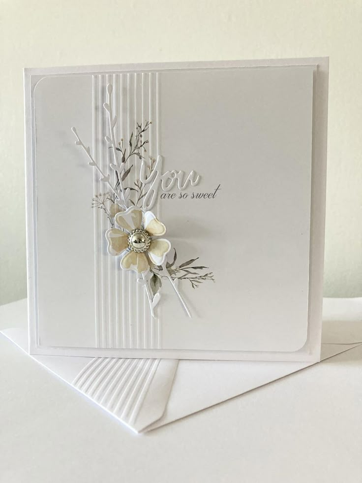 a white card with some flowers on it