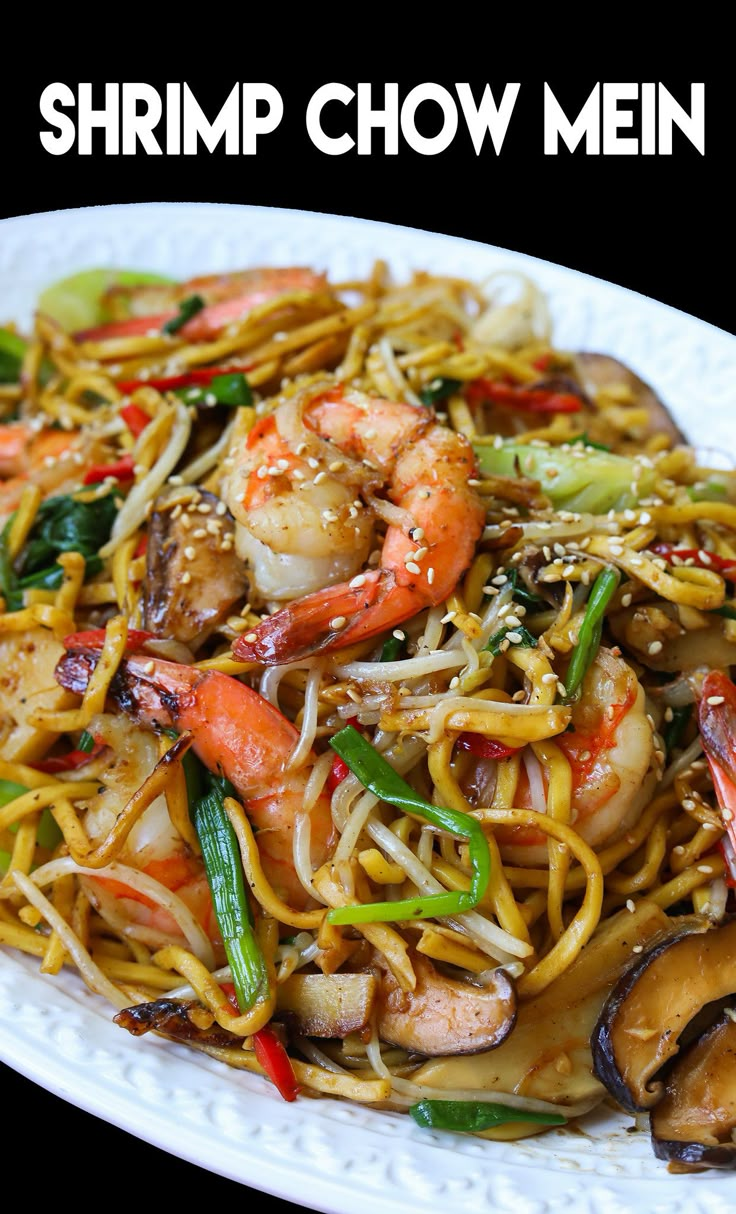 shrimp chow mein with noodles and vegetables on a white plate in front of a black background