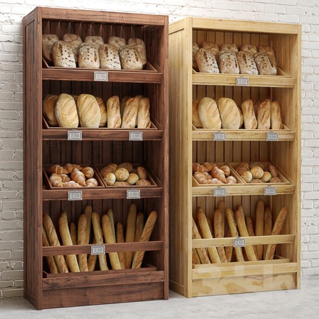 two wooden shelves filled with bread next to each other