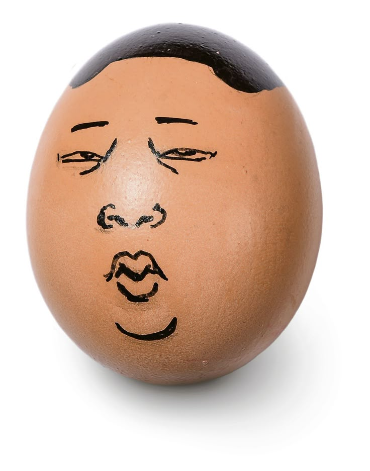 an egg with a drawing of a man's face drawn on the inside of it