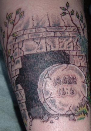 a man's arm with a memorial tattoo on it