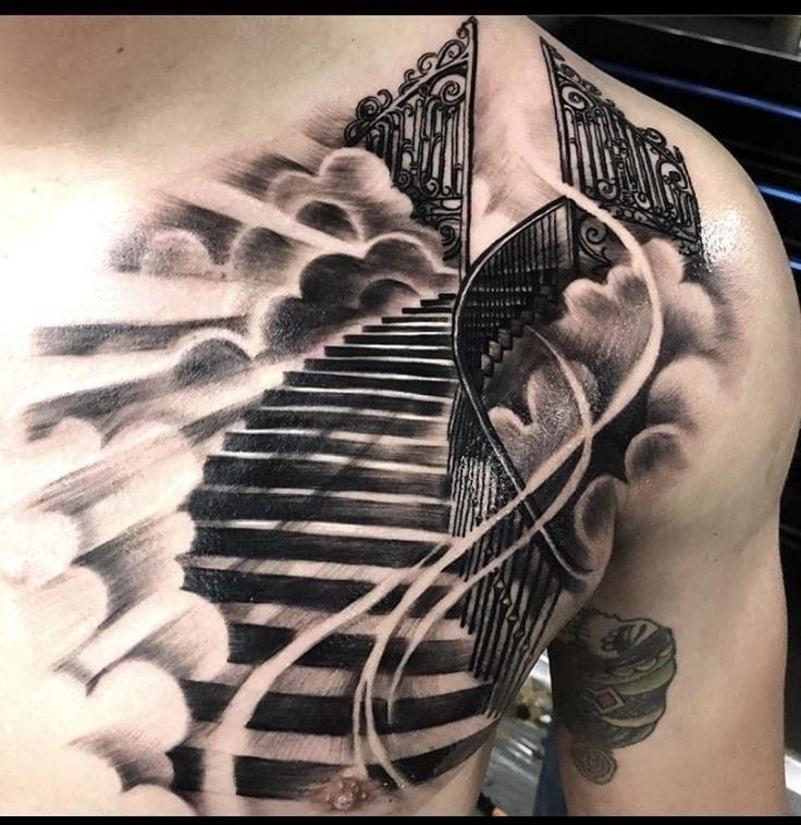 a man's back with a black and white tattoo on his chest that has stairs going up into the sky