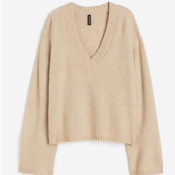 Loose-Fit Sweater In A Soft Knit With Wool Content. V-Neck, Dropped Shoulders, And Long Sleeves. Ribbing At Neck, Cuffs, And Hem. Length: Regular Length Sleeve Length: Long Sleeve Fit: Loose Fit Neckline: V-Neck Description: Beige, Solid-Color