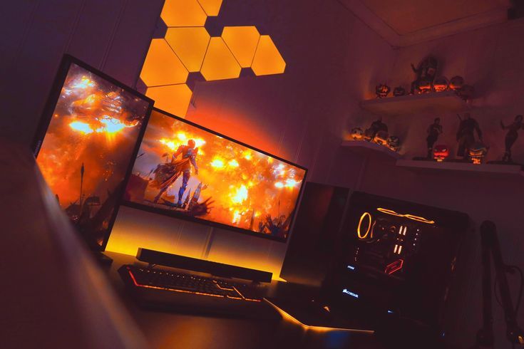 two computer monitors sitting on top of a desk