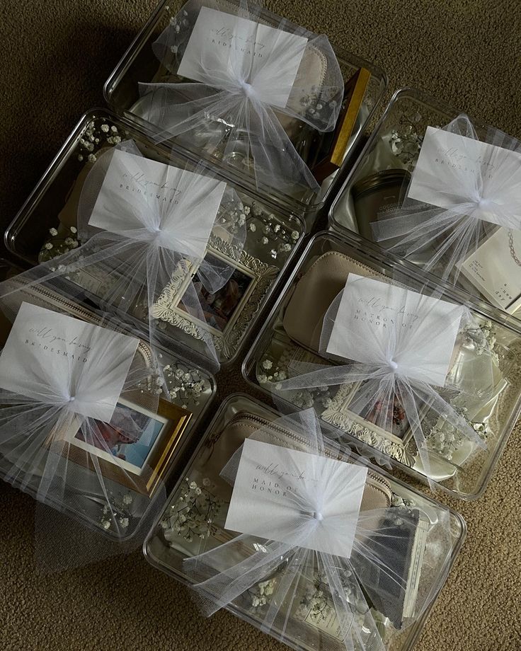 four clear plastic containers filled with items on top of a carpeted floor next to each other