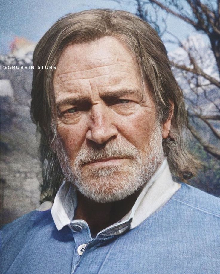 an older man with long hair and beard wearing a blue shirt looking at the camera