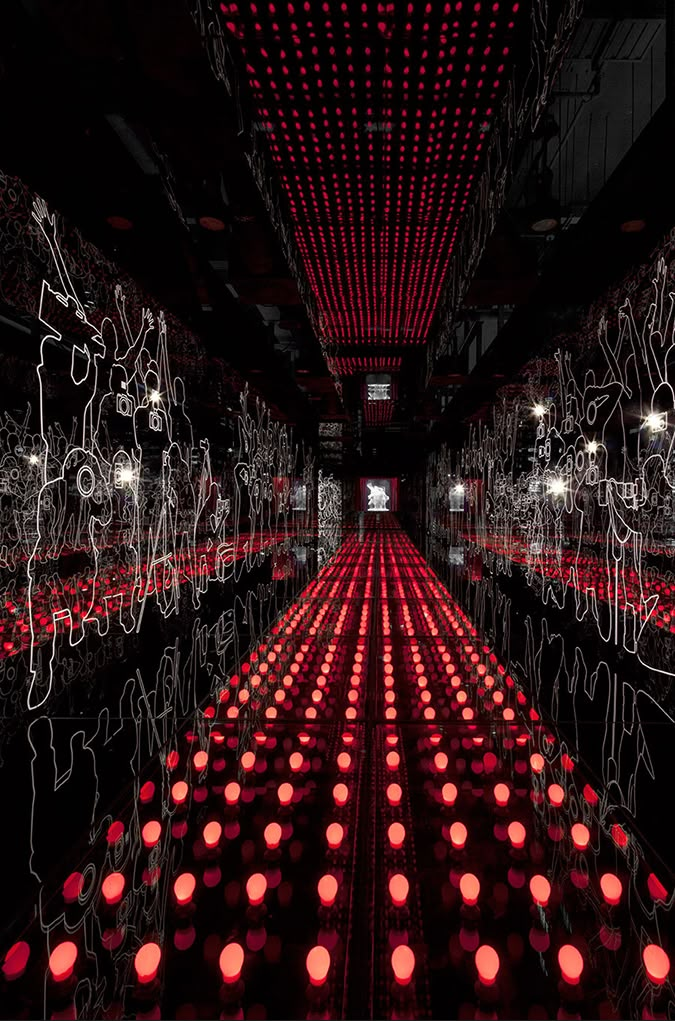 an image of a room with red lights on the ceiling and some black and white images