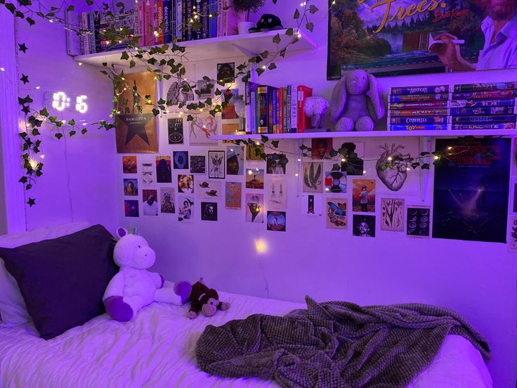 a bedroom with purple lighting and pictures on the wall above the bed, along with a teddy bear