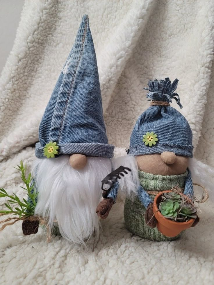 two small garden gnomes are sitting next to each other