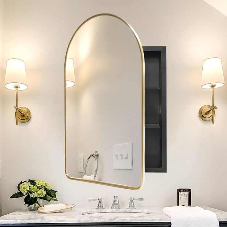 a bathroom with a sink, mirror and two lights on the wall next to it