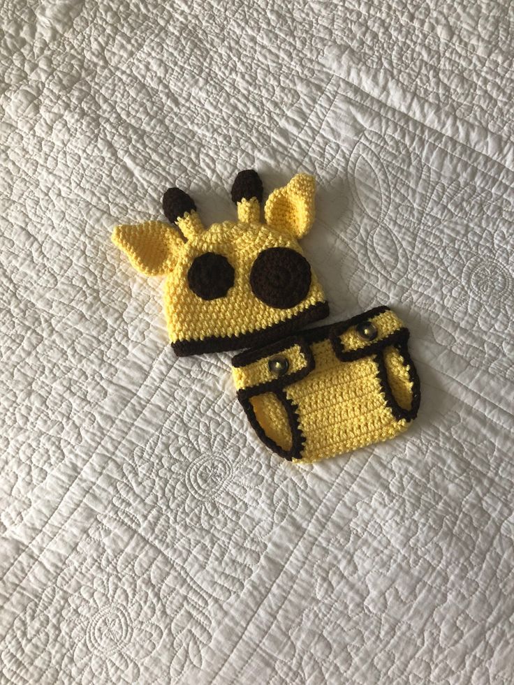 "Are you looking for an animal halloween costume for you baby?  This giraffe 2-piece outfit would be perfect.  It would also make a great photo prop. This hand crocheted giraffe hat and diaper cover is so soft and luxurious to the touch.  It is made from 100% acrylic yarn. The main body of the giraffe set is a  sun yellow.  The diaper cover has an adjustable waist band.  Just move over the button to make it larger or smaller. Check out the chocolate brown spots on the hat.  The hats circumference is 14\" and is sized 0-3 months. The diaper cover is sized 0-3 months.  I recommend machine wash gentle and lay flat to dry.   >0-3 months >Hat circumference is 14\" >100% hand crocheted >100% acrylic yarn >Machine wash gentle/lay flat to dry >Pattern by Ava Girl Designs >Baby doll not included >R Giraffe Hat Crochet Pattern Free, Crochet Giraffe Baby Hat, Crocheted Giraffe, Halloween Costume Newborn, Animal Halloween Costume, Baby Animal Costumes, Newborn Christmas Outfit, Giraffe Hat, Infant Halloween