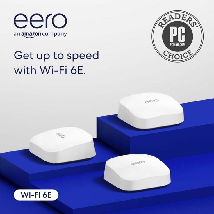 two white wi - fi devices sitting on top of each other in front of a sign that says, get up to speed with wi - fi - fi 6e