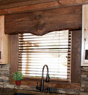 a kitchen with wooden blinds and granite counter tops