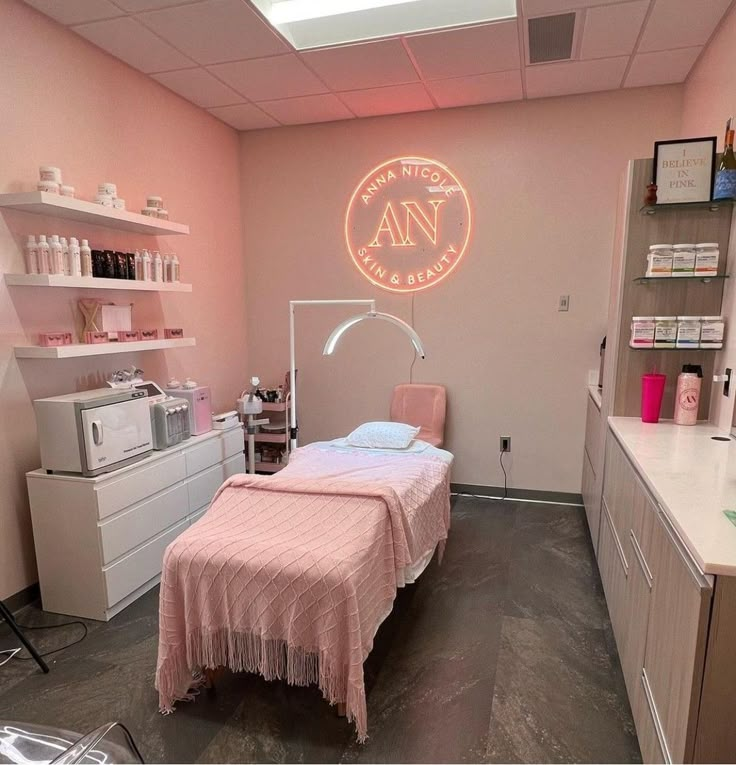 a pink room with a bed, desk and shelves on the wall next to it