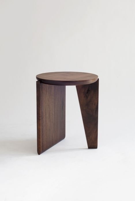 a small wooden stool sitting on top of a white floor