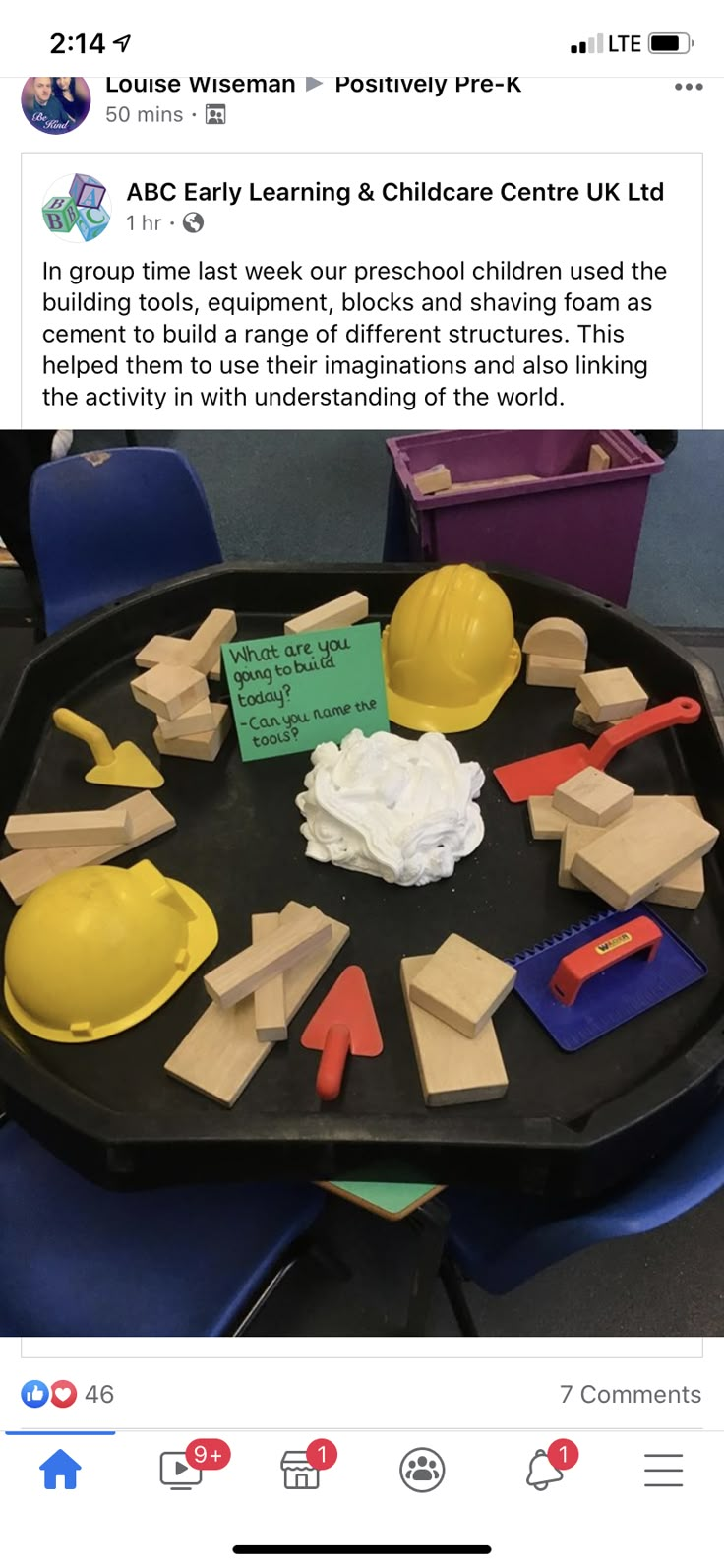 a black tray topped with construction themed wooden toys