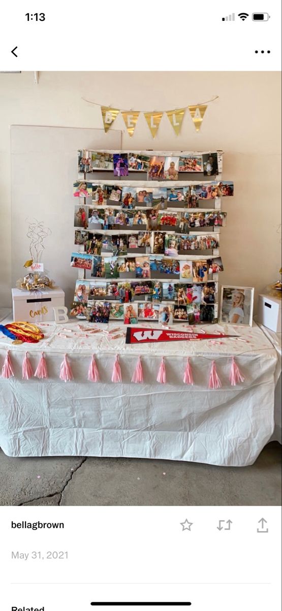 an image of a table with pictures on it and pink tassels hanging from the top