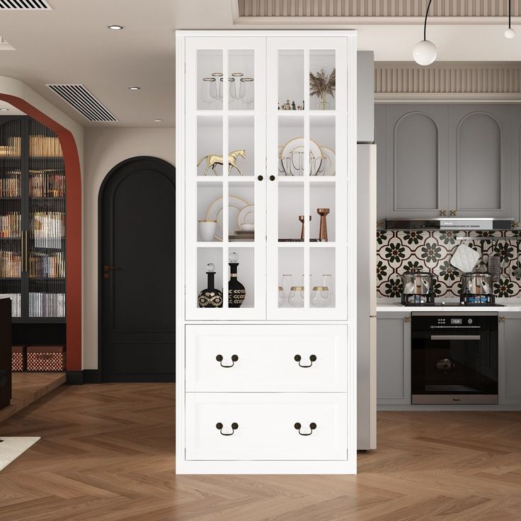 a white china cabinet in the middle of a kitchen