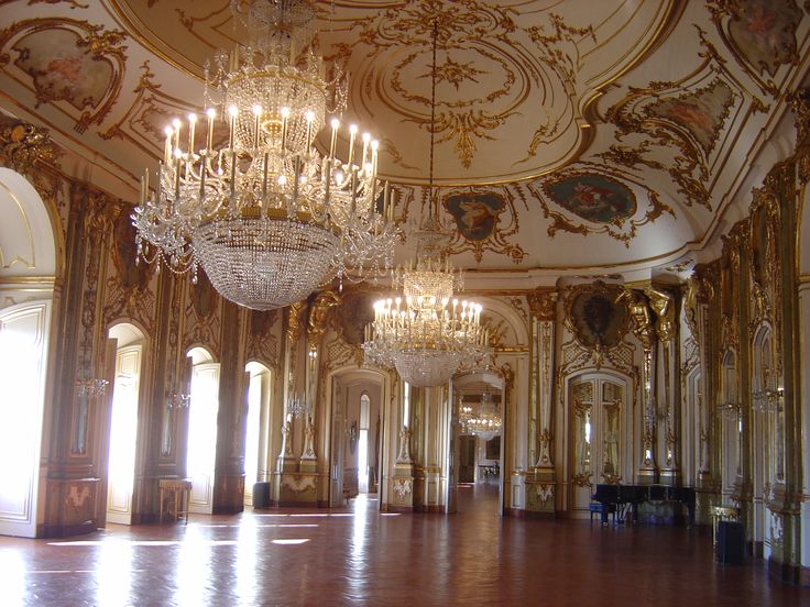 an ornate ballroom with chandeliers and mirrors