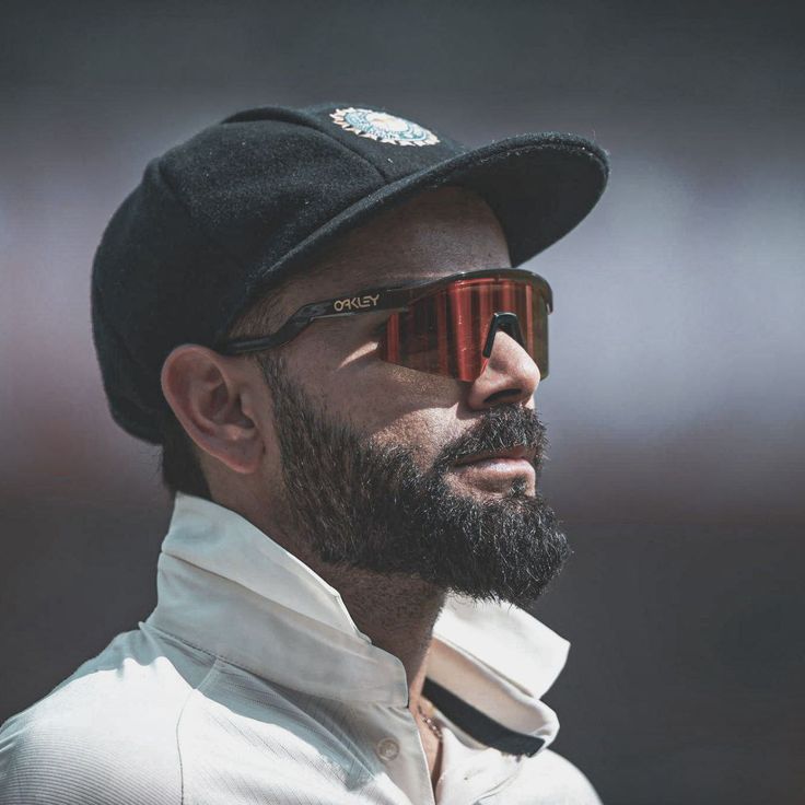 a close up of a man wearing sunglasses and a hat