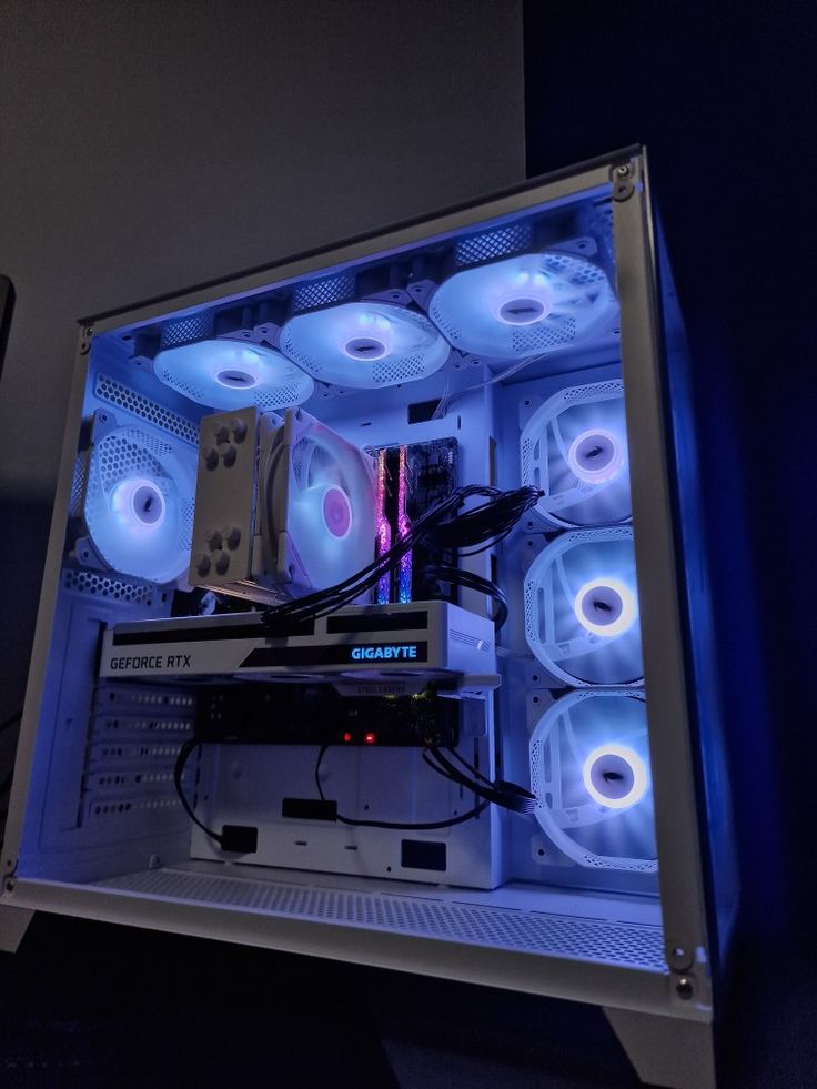 the inside of a computer case is lit up with blue lights and some sort of electronic equipment