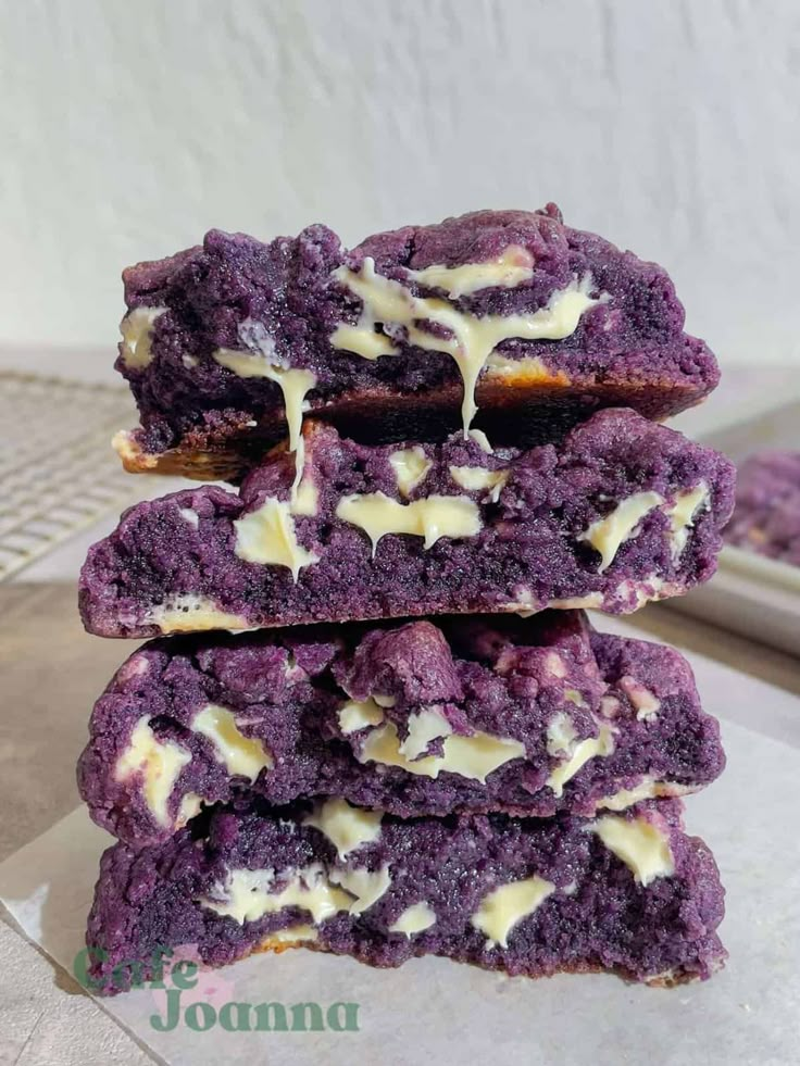 three purple cookies stacked on top of each other