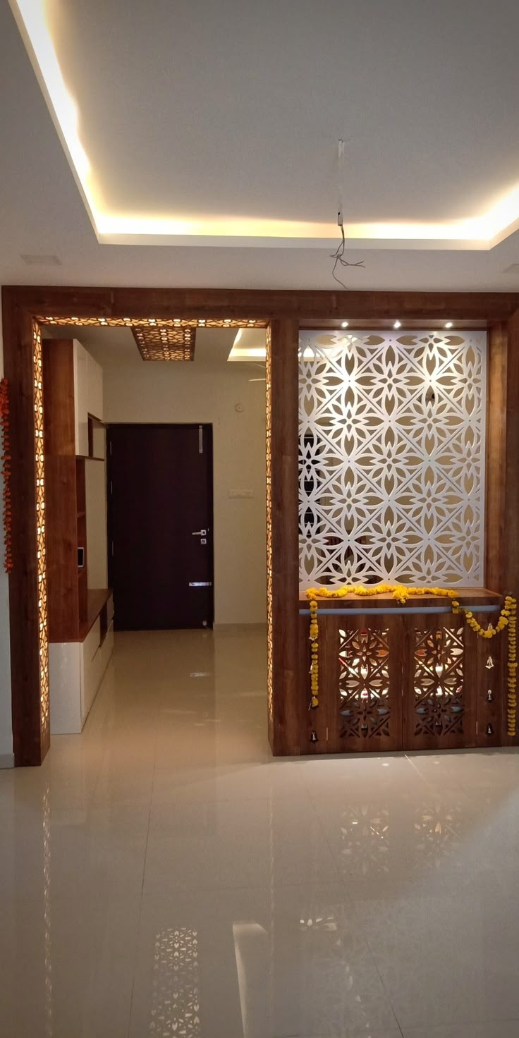 an empty room with white tile floors and decorative screens on the wall, along with yellow ribbons