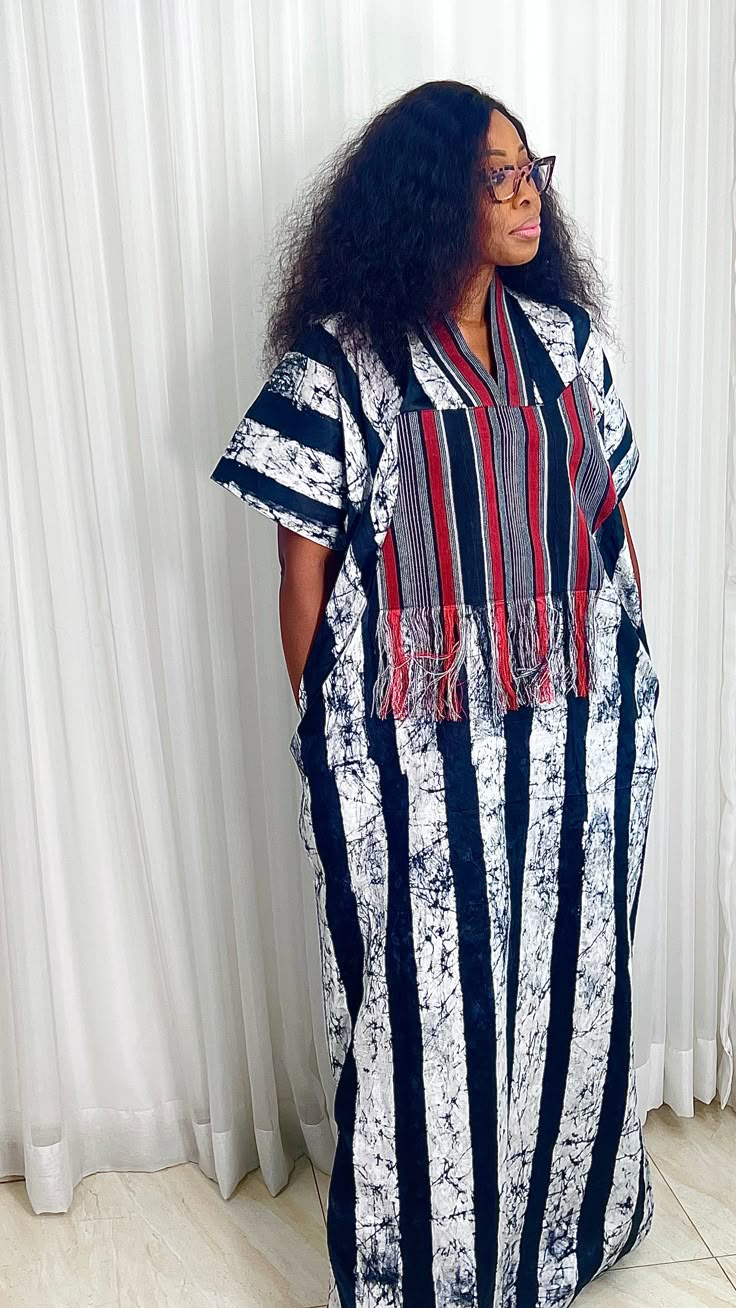 This Adire Ankara Silk Kaftan maxi dress is made with Polysilk. It can be styled in different ways, you can dress it up with high heels or dress down with flats/sneakers. The Hand can be worn in 2 ways. one ways shows off the arm, the 2nd way has the arm covered for modesty. Notice the slits.Other prints are also available, kindly start a conversation to ask for more information and pics.Contact us for custom looks and more style options. Sizing 🌺 Your height or desired kaftan length is needed. Ankara Dress With Sneakers, Silk Kaftan Dress Style, Kaftan Dress Ankara, Adire Dress Styles, Silk Kampala Styles, Adire Bubu Styles, African Fashion Dresses Classy, Ankara Kaftan Styles For Women, Adire Boubou Styles For Women