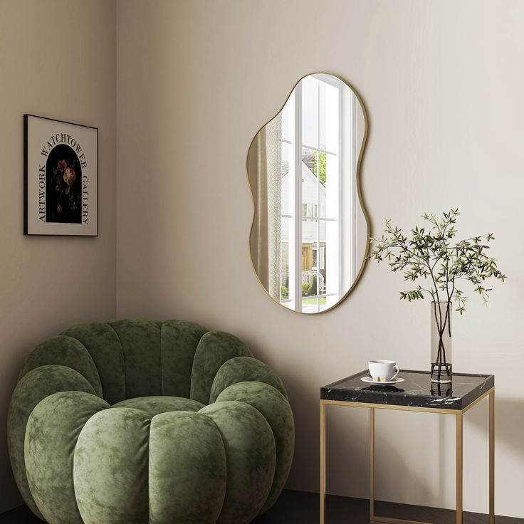 a living room with a green chair and a round mirror on the wall next to a small table