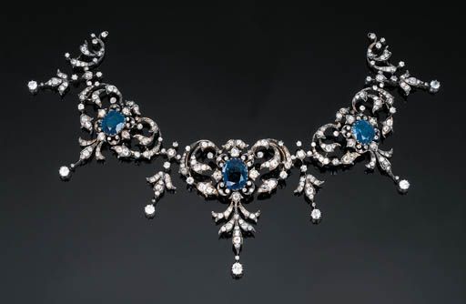 An Antique Sapphire and Diamond Tiara Necklace   Of scrolled and foliate design, set with three openwork graduated clusters each centred by an oval-cut sapphire, with the largest sapphire weighing 9.46 carats, circa 1880, mounted in silver and gold, 21.5 cm long, tiara attachment separate Tiara Necklace, Vintage Jewlery, Diamond Tiara, Historical Jewellery, Royal Jewels, Royal Jewelry, Sapphire Necklace, Victorian Jewelry, Fantasy Jewelry