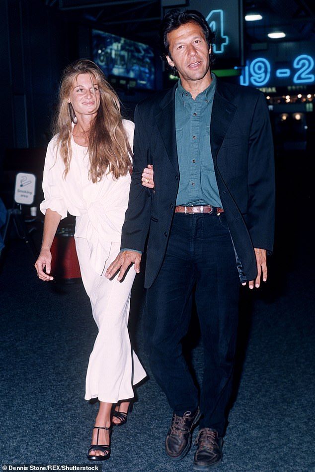 a man and woman walking through an airport