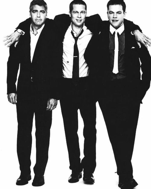 three men in suits and ties posing for the camera