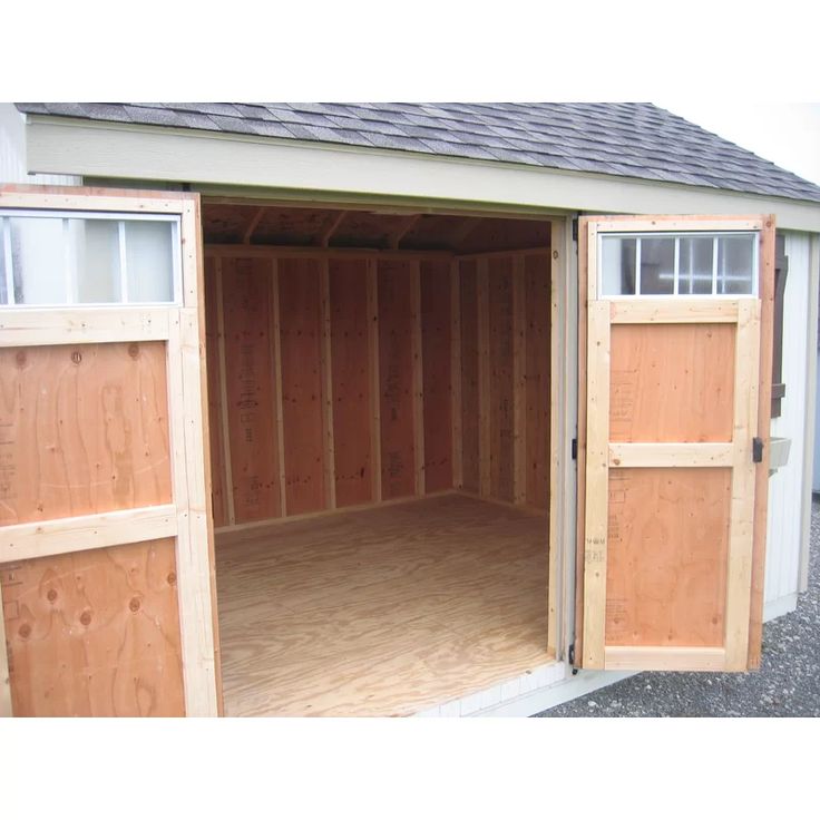 an empty garage with the doors open