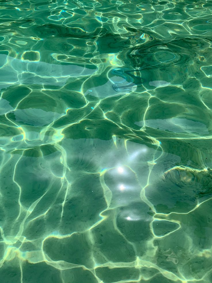 the water is very clear and blue with some light reflecting off it's surface